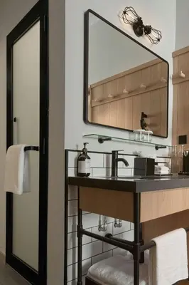 a bathroom with a sink and a mirror at Moxy Kuala Lumpur Chinatown in Kuala Lumpur