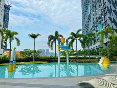a swimming pool in a city with palm trees at 5 STAR Homestay 3R3B KL View Trion TRX Velocity in Kuala Lumpur