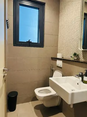 a bathroom with a toilet and a sink and a window at Stylish Apartment at Lucentia residence BBCC Lalaport in Kuala Lumpur