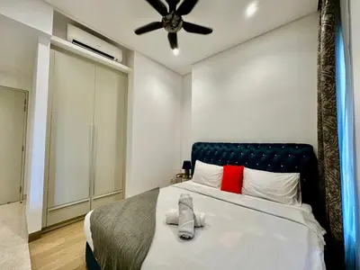 a bedroom with a bed with a ceiling fan at Stylish Apartment at Lucentia residence BBCC Lalaport in Kuala Lumpur