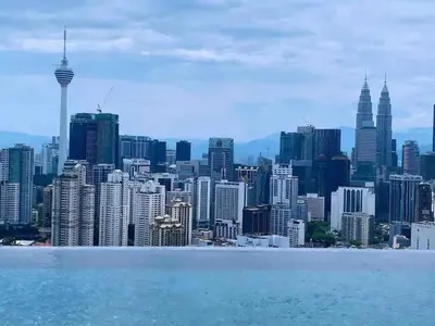 a view of the kuala lumpur city skyline at The BirdsEye View facing KLCC with Gorgeous pools in Kuala Lumpur