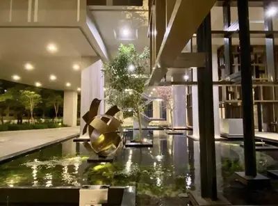 a house with a pond in the middle of a house at The BirdsEye View facing KLCC with Gorgeous pools in Kuala Lumpur