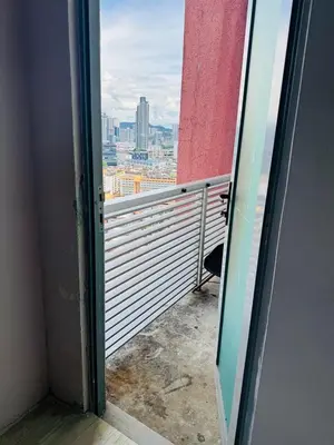 an open door to a balcony with a view of a city at Taragon Standard Homestay in Kuala Lumpur