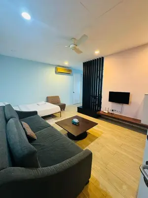 a living room with a couch and a flat screen tv at Taragon Standard Homestay in Kuala Lumpur