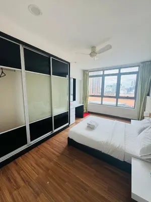 a bedroom with a large bed and a large window at Taragon Standard Homestay in Kuala Lumpur