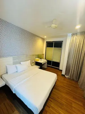 a large white bed in a room with a window at Taragon Standard Homestay in Kuala Lumpur