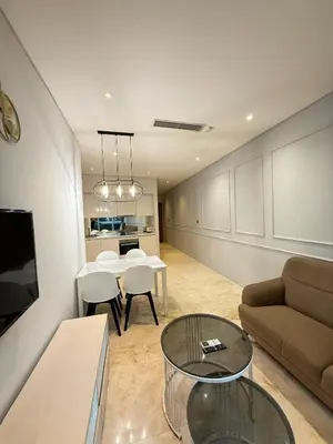 a living room with a couch and a table at Sky Suites KLCC host by REST Corner Suites in Kuala Lumpur