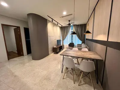 a room with a table and chairs and a couch at Sky Suites KLCC host by REST Corner Suites in Kuala Lumpur