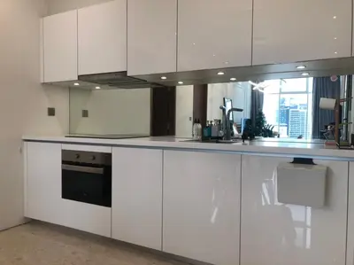 a white kitchen with white cabinets and a window at Sky Suites KLCC host by REST Corner Suites in Kuala Lumpur