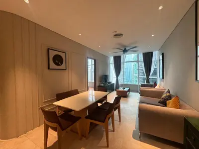 a living room with a table and a couch at Sky Suites KLCC host by REST Corner Suites in Kuala Lumpur