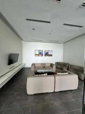 a living room with a couch and a flat screen tv at 1 Bukit Ceylon Kuala Lumpur in Kuala Lumpur