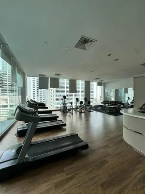 a gym with rows of treadmills and exercise bikes at 1 Bukit Ceylon Kuala Lumpur in Kuala Lumpur