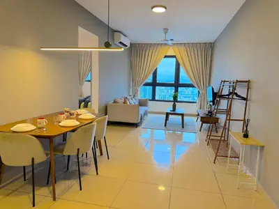 a dining room and living room with a table and chairs at M Vertica Cheras by RASBO Galaxy Suites in Kuala Lumpur