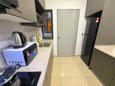 a small kitchen with a microwave on a counter at M Vertica Cheras by RASBO Galaxy Suites in Kuala Lumpur