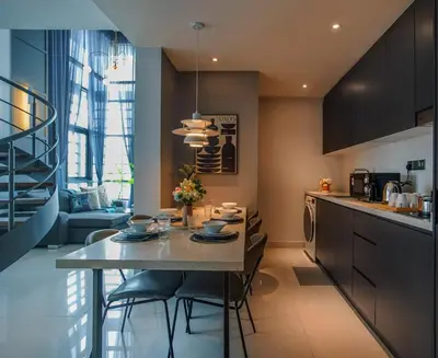 a kitchen with a table and chairs in a kitchen at Novo Ampang, Luxury Premium 3BR Penthouse, Kuala Lumpur by Cobnb in Kuala Lumpur