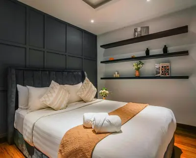a bedroom with a large bed with white sheets at Novo Ampang, Luxury Premium 3BR Penthouse, Kuala Lumpur by Cobnb in Kuala Lumpur