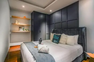 a bedroom with a large bed with a black headboard at Novo Ampang, Luxury Premium 3BR Penthouse, Kuala Lumpur by Cobnb in Kuala Lumpur