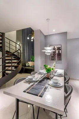 a dining room with a white table and chairs at Novo Ampang, Luxury Premium 3BR Penthouse, Kuala Lumpur by Cobnb in Kuala Lumpur