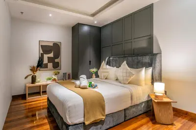 a bedroom with a large bed with a large headboard at Novo Ampang, Luxury Premium 3BR Penthouse, Kuala Lumpur by Cobnb in Kuala Lumpur