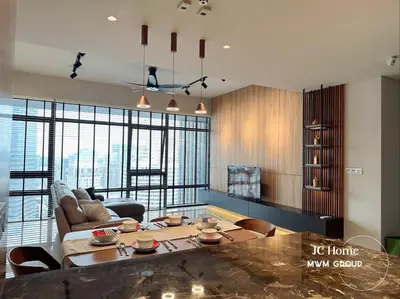 a living room with a table and a couch at The Anggun l 5-star Bathtub Suites By MWM in Kuala Lumpur