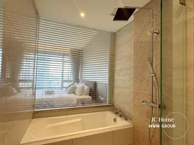a bath tub in a bathroom with a window at The Anggun l 5-star Bathtub Suites By MWM in Kuala Lumpur