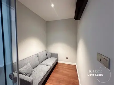 a living room with a couch in the corner at The Anggun l 5-star Bathtub Suites By MWM in Kuala Lumpur