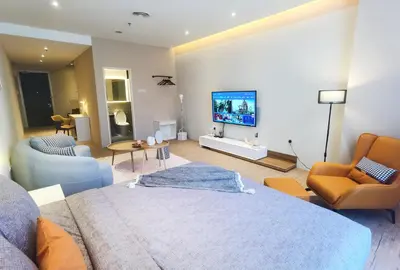 a living room with a bed and a tv on a wall at Weekly Monthly Stay - Bangsar Trade Centre Curvena in Kuala Lumpur