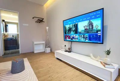 a living room with a large flat screen tv on a wall at Weekly Monthly Stay - Bangsar Trade Centre Curvena in Kuala Lumpur