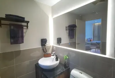 a bathroom with a sink and a mirror at Weekly Monthly Stay - Bangsar Trade Centre Curvena in Kuala Lumpur