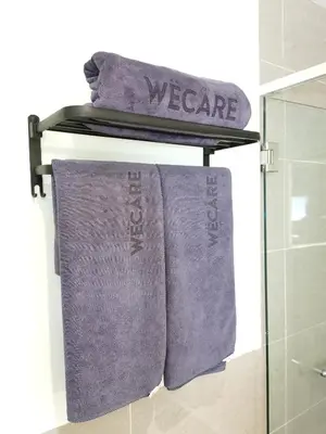 a towel rack with purple towels on it in a bathroom at Weekly Monthly Stay - Bangsar Trade Centre Territory in Kuala Lumpur