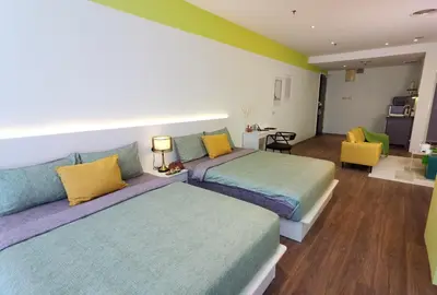 a bedroom with two beds and a living room at Weekly Monthly Stay - Bangsar Trade Centre Territory in Kuala Lumpur