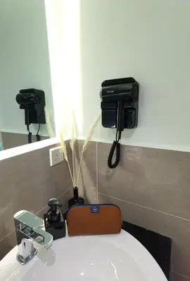 a bathroom with a sink with two cameras on the wall at Weekly Monthly Stay - Bangsar Trade Centre Territory in Kuala Lumpur