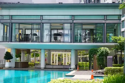 a large building with a swimming pool in front of it at KL V Residence I with Balcony I 吉隆坡双威伟乐城民宿-附有阳台 I Walking distance to MRT & Mall & Nanjing Street I 马中英服务 I Malay English Chinese in Kuala Lumpur