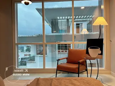 a bedroom with a chair and a large window at Binjai 8Premium KL city Walkabke to KLCC By MWM in Kuala Lumpur