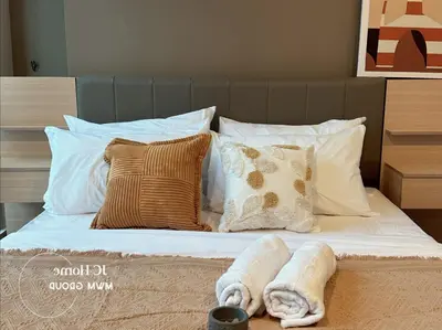 a bed with pillows and towels on it at Binjai 8Premium KL city Walkabke to KLCC By MWM in Kuala Lumpur