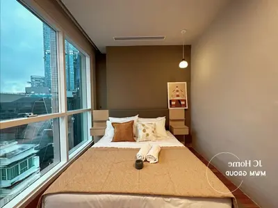 a bed in a room with a large window at Binjai 8Premium KL city Walkabke to KLCC By MWM in Kuala Lumpur