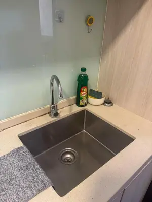 a kitchen counter with a stainless steel sink at Sunway Velocity in Kuala Lumpur