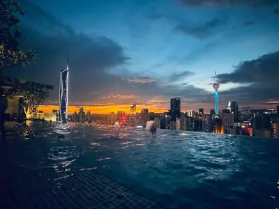 a swimming pool with a city skyline in the background at AXON Bukit Bintang Suites KL in Kuala Lumpur