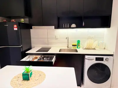 a kitchen with a sink and a washing machine at Axon Residence Bukit Bintang by TaheeenS in Kuala Lumpur