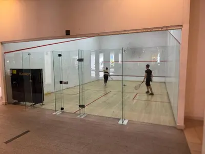 a man and a woman playing a game of squash at Infinity Skypool hostel in Kuala Lumpur