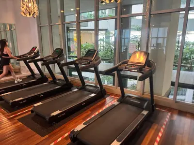 a row of treadmills in a gym at Infinity Skypool hostel in Kuala Lumpur
