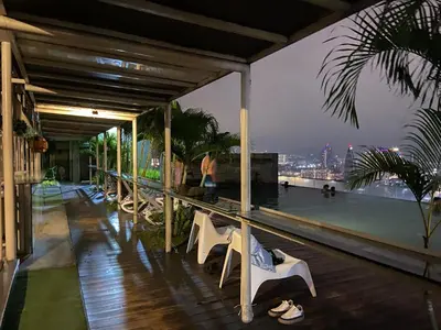 a balcony with chairs and a view of the city at Infinity Skypool Retreat hostel in Kuala Lumpur