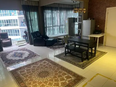 a living room with a black table and chairs at Infinity Skypool Retreat hostel in Kuala Lumpur