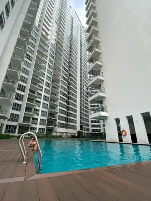 a swimming pool in front of a large building at Infinity Skypool hostel in Kuala Lumpur