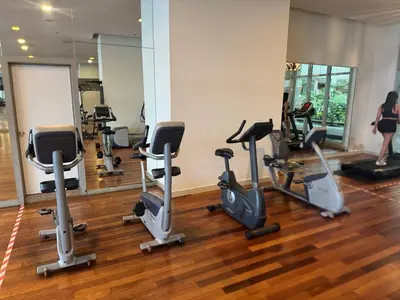 a gym with several treadmills and exercise bikes at Infinity Skypool hostel in Kuala Lumpur