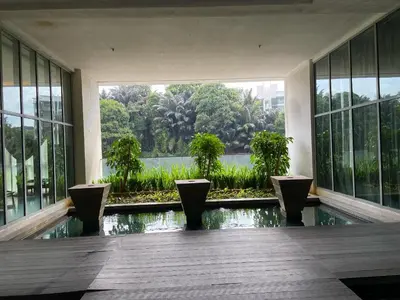 a room with a pool in a building with windows at Infinity Skypool hostel in Kuala Lumpur