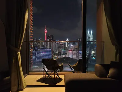 a room with a view of a city at night at Lucentia Residence, Bukit Bintang City Centre in Kuala Lumpur