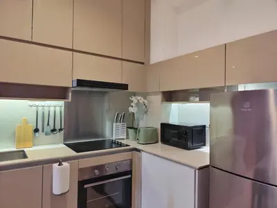 a kitchen with a refrigerator and a microwave at Lucentia Residence, Bukit Bintang City Centre in Kuala Lumpur