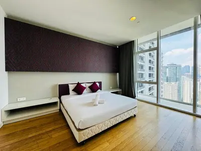 a bedroom with a large bed and a large window at The Platinum Kuala Lumpur by Skyscraper in Kuala Lumpur
