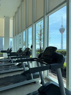 a row of treadmills in a gym with a view at The Platinum Kuala Lumpur by Skyscraper in Kuala Lumpur